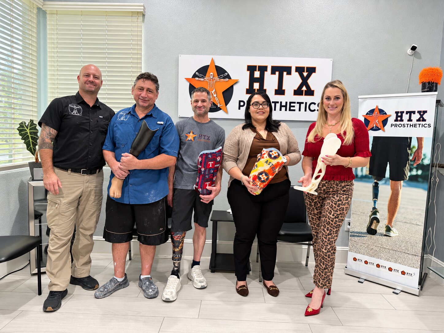 HTX Prosthetics team together at the office with custom prostheses